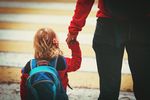 parent walking little daughter to daycare