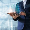 Businessman using tablet analyzing sales data and economic growt